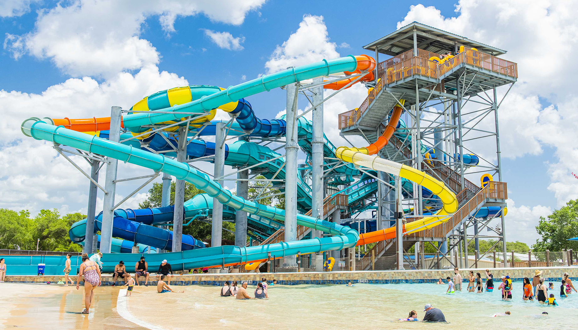 Splashway_1079 copy An overhead view of a brightly colored water slide complex with intertwined colored tubes.